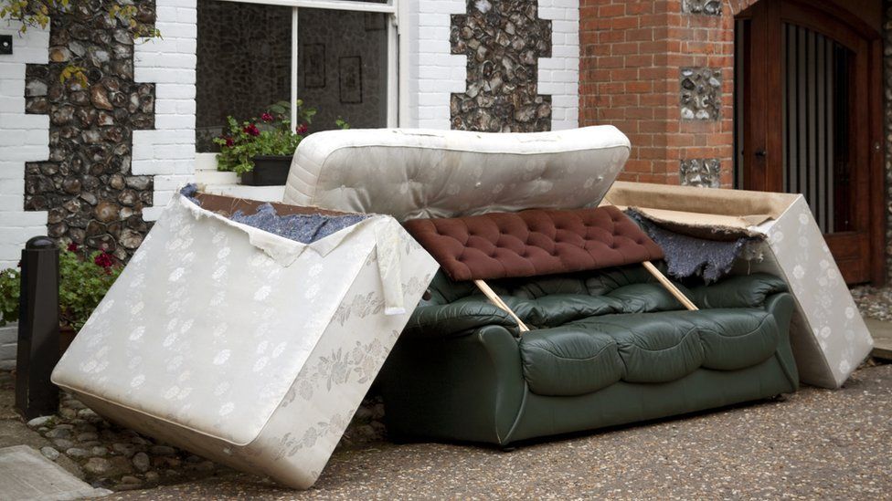 Furniture piled up outside a house