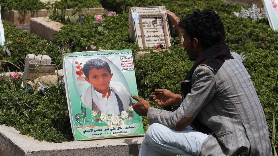 A Yemeni man sits nearby the grave of Yemeni child Bilal al-Asadi who was reportedly killed in a Saudi-led air strike in Sanaa (4 June 2016)