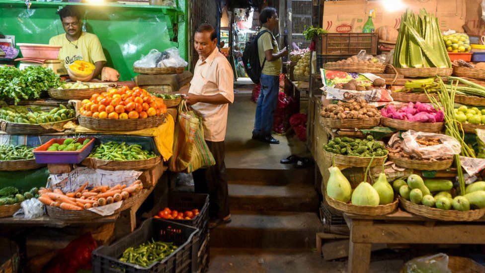 Consumers and sellers as seen at a vegetable market in Kolkata , India , on 12 July 2023 . Spiraling prices of tomato, onion and pulses are emerging as new risks that is fueling India's retail inflation to 4.6 % in June ,The El Nino influence paired with reducing WPI on retail inflation has made the situation worse for consumers according to finance ministry reports.