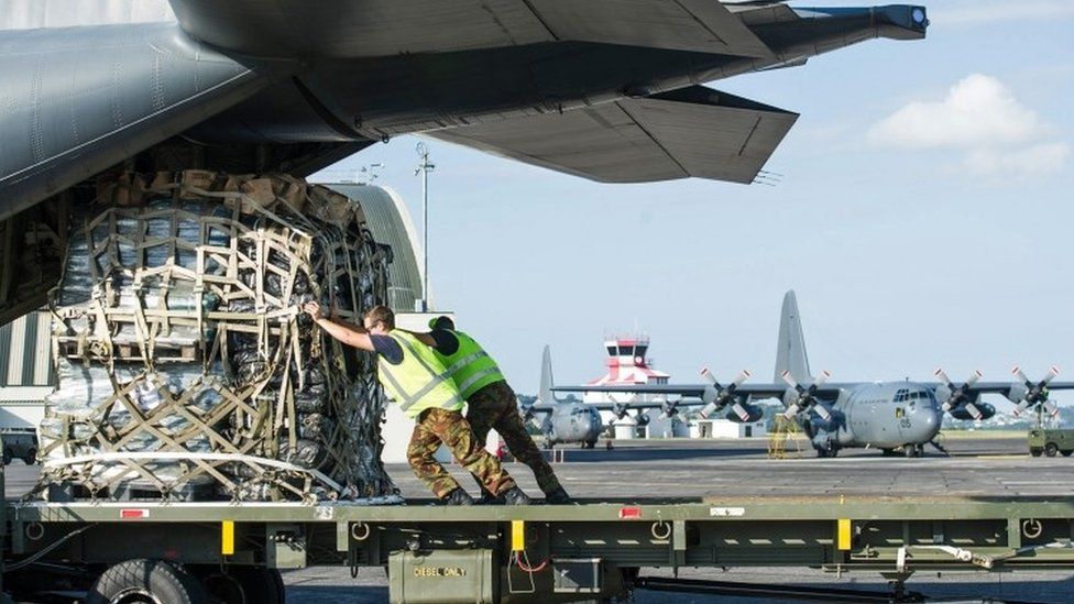 Royal New Zealand Air Force personnel load aid supplies for Cyclone Winston relief on board a C-130 Hercules transport aircraft bound for Fiji (22 February 2016)