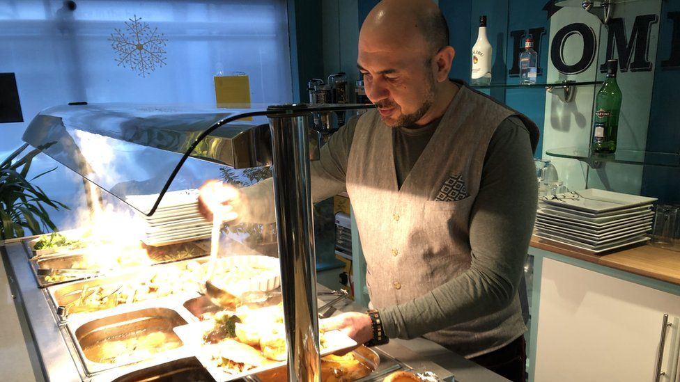Ahmet Acikel serving food