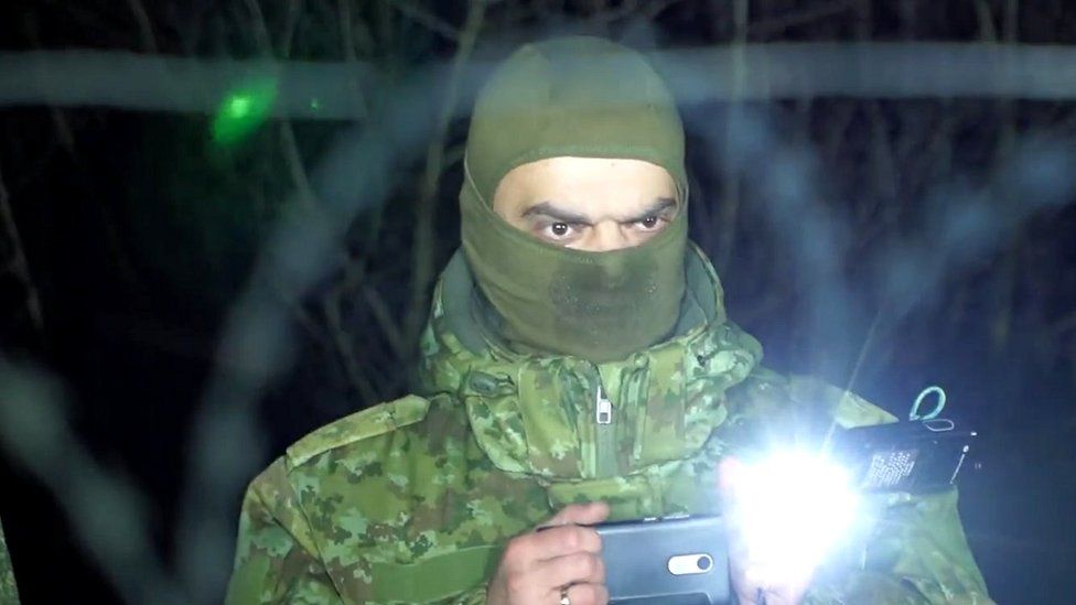 A Belarusian soldier is filmed by Polish authorities while filming at the border