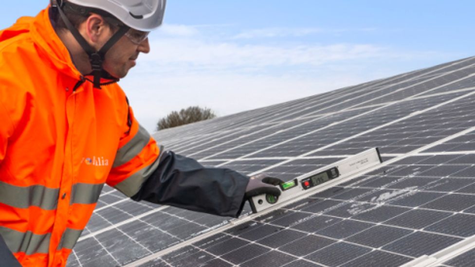 A man installing a solar roof