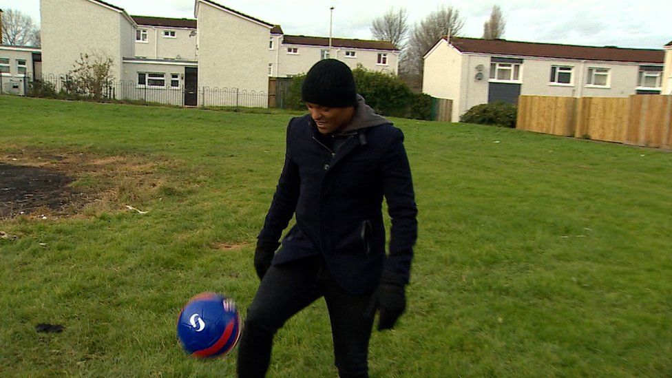 Earnshaw playing on the patch of grass outside his childhood home in Snowden Court