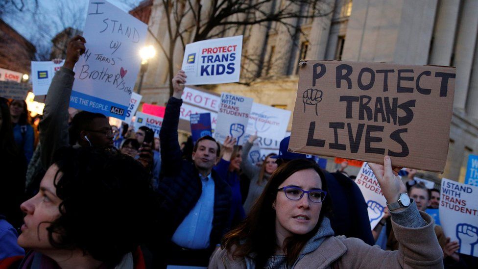 Transgender activists and supporters protest potential changes by the Trump administration in federal guidelines issued to public schools in defense of transgender student rights, near the White House