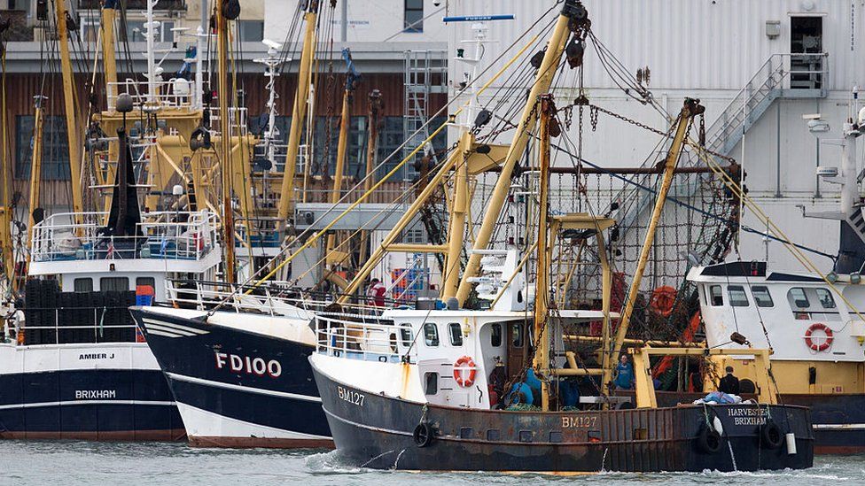 The Harvester beam trawler heads out to sea after being moored in Brixham harbour