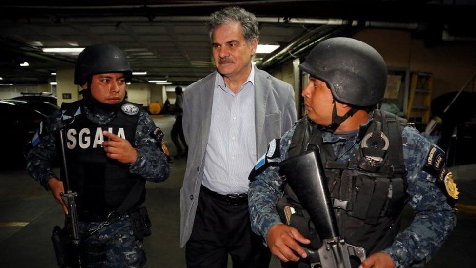 Former finance minister and current chairman of Oxfam International Juan Alberto Fuentes arrives to court escorted by policemen after being detained as part of a local corruption investigation, in Guatemala City, Guatemala February 13, 2018.