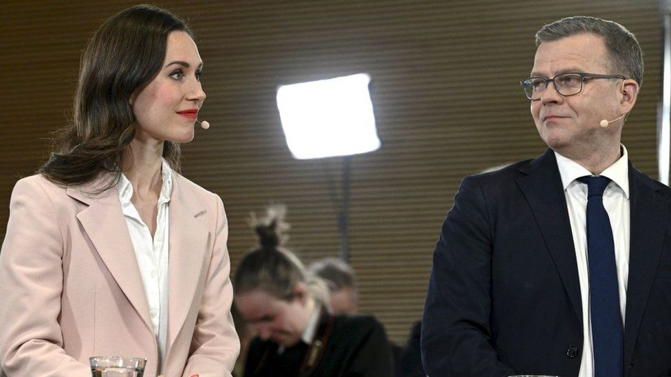 National Coalition Party chair Petteri Orpo (R) looks at Social Democratic Party SDP chair and Finnish Prime Minister Sanna Marin during an official election event at Pikkuparlamentti, following the Finnish parliamentary elections, on April 2, 2023, in Helsinki
