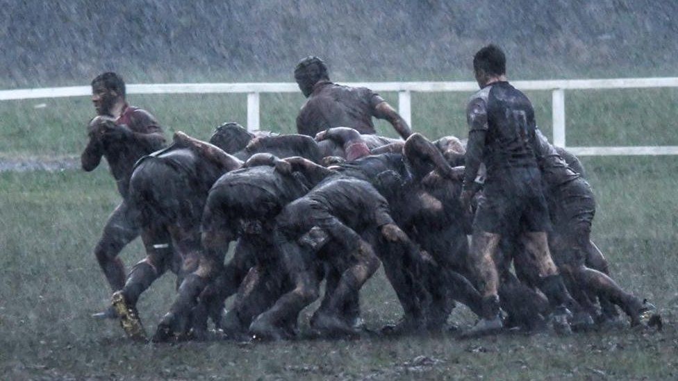muddy rugby players