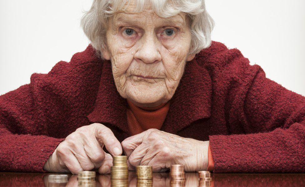Old lady counting her coins