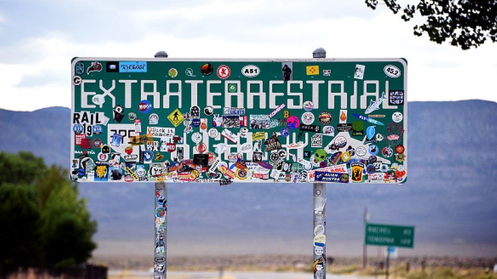 An Extraterrestrial Highway sign covered with stickers is seen along state route 375