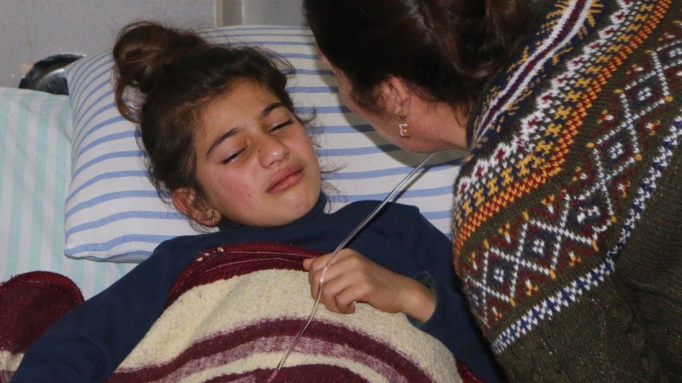 A mother comforts her wounded daughter at a hospital in the Kurdish enclave of Afrin, Syria (20 February 2018)