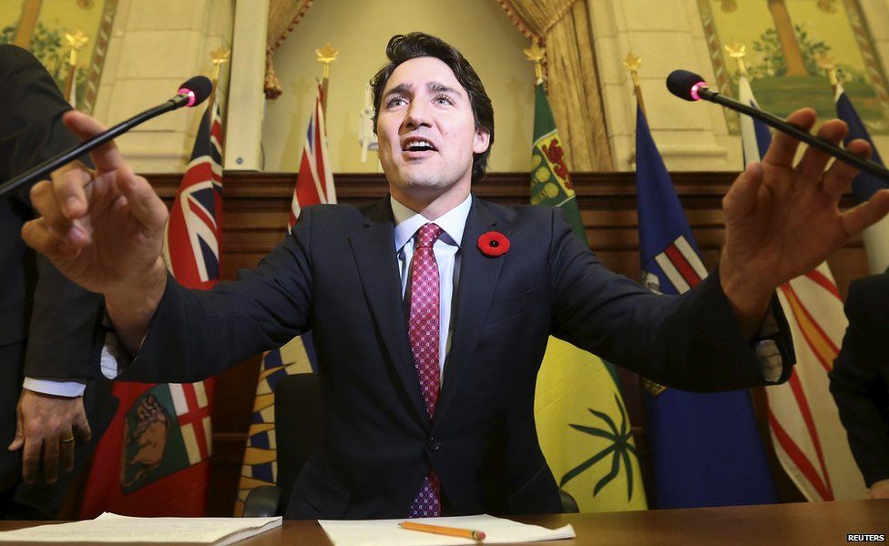 Justin Trudeau holds two microphones