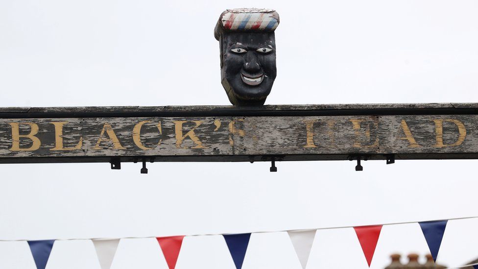 Sign above The Green Man and Black's Head Hotel