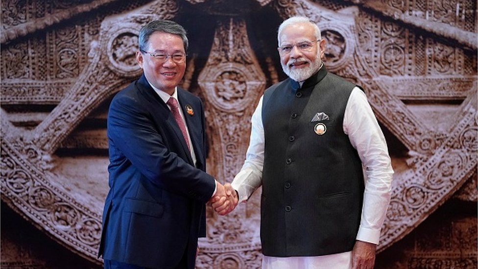 India's Prime Minister Narendra Modi (R) shakes hand with Chinese Premier Li Qiang ahead of the G20 Leaders' Summit in New Delhi on September 9, 2023.