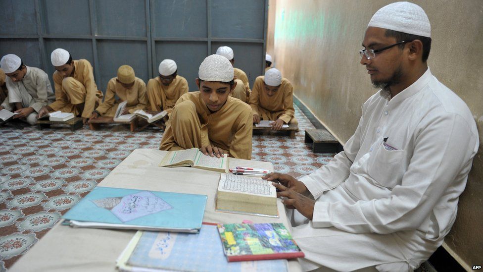 Indian Muslim students recite from the Koran in a classroom at the Madrasa Islamia Darul-Uloom Ashrafia in Hyderabad 24 June 2015