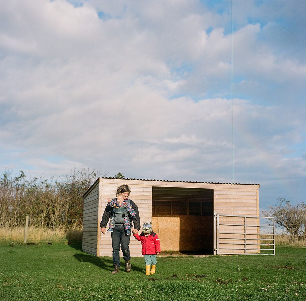 Anna works on her farm with her children in north Northumberland