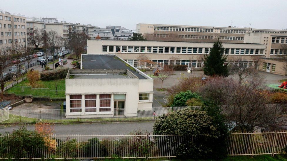 Police outside the school in Aubervilliers, 14 Dec