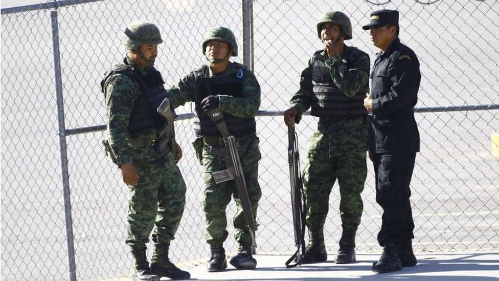 Soldiers and a police officer stand guard at a prison to be visited by Pope Francis in Ciudad Juarez, Chihuahua State, Mexico, on 17 February, 2016