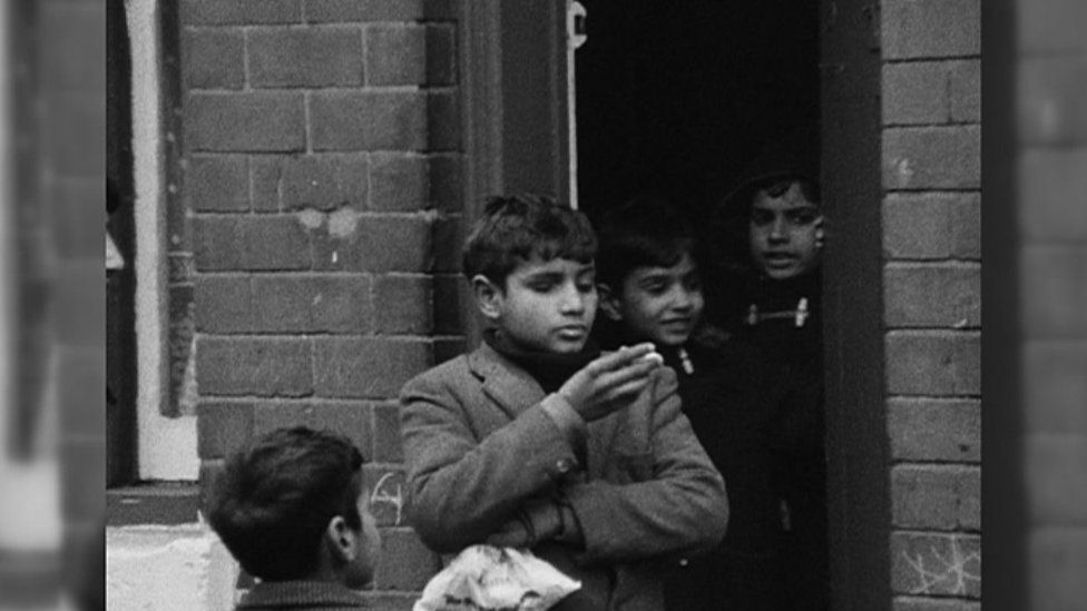 Young boys gathered at a front doorway