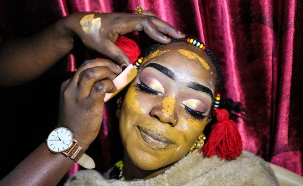 Dallifa Suleiman poses whilst having her make-up done before the traditional Islamic wedding in Kenya's Kibera slum - 7 August 2019