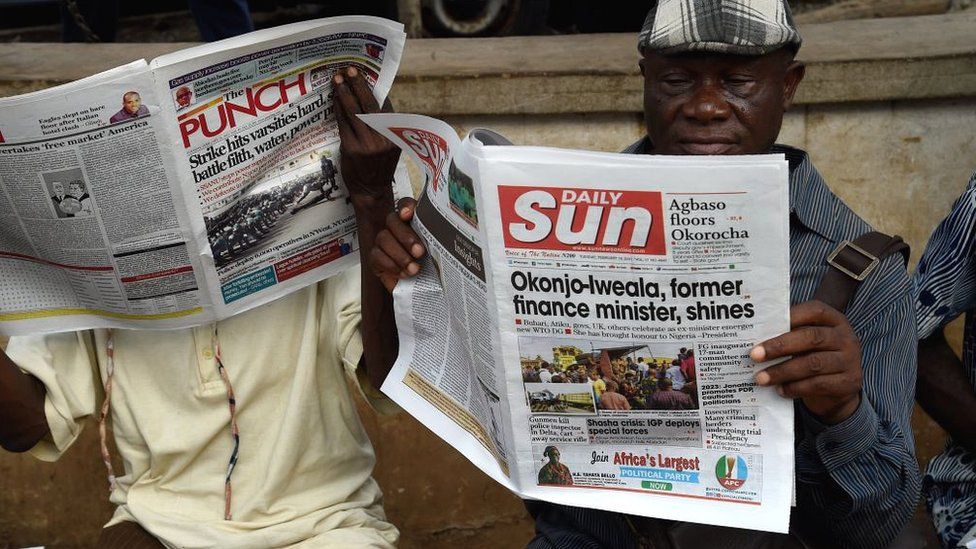 A man reads a newspaper on the appointment of Ngozi Okonjo-Iweala as WTO Secretary-General, in Ibadan, southwest Nigeria, on February 16, 2021