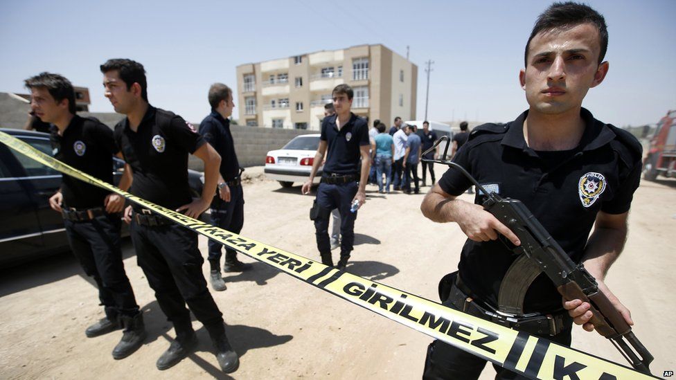 Police outside the building where the bodies were found on 22 July, 2015