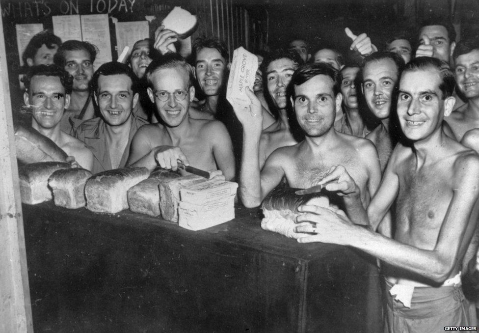 1945: Prisoners of War from the Allied forces eating food after being liberated from a Japanese Prisoner of War camp in Taiwan