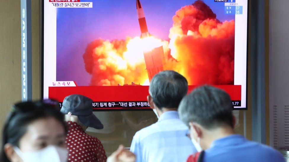 People watch a TV showing a file image of a North Korean missile launch at the Seoul Railway Station on September 15, 2021 in Seoul, South Korea.