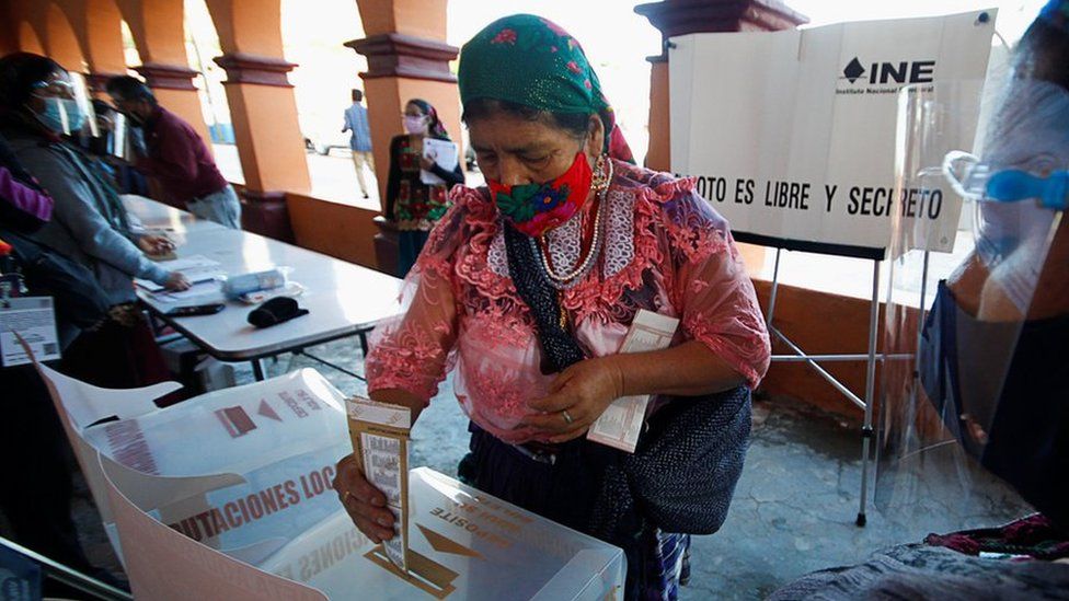An indigenous Zapotec woman casts her vote at a polling station during the mid-term elections in the rural village of San Bartolome Quialana