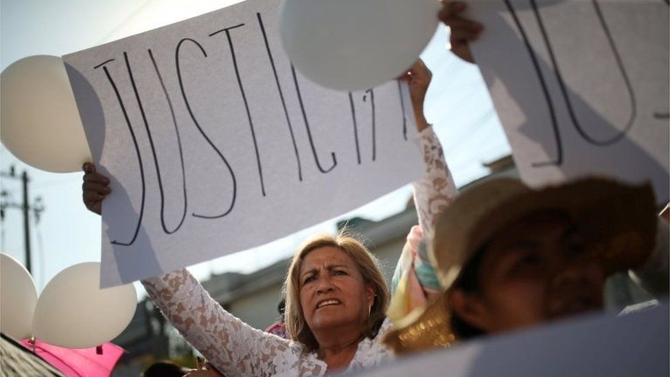 A woman holds a sign during the funeral of seven-year-old Fatima Cecilia Aldrighett in Mexico City, Mexico February 18, 2020.