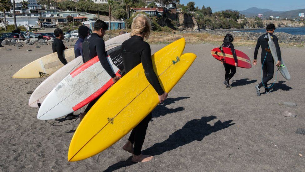 Surfers head to the sea in honour of the three foreign surfers murdered in Ensenada