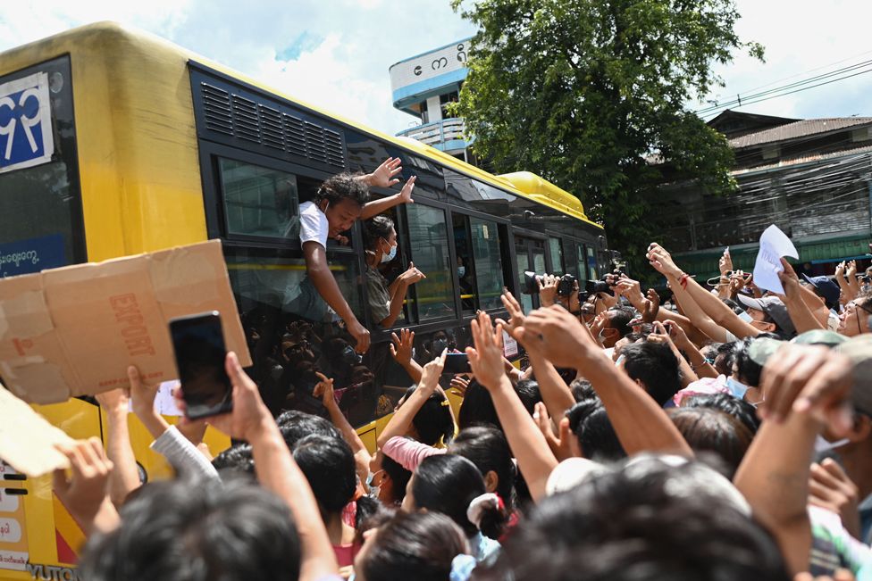 Detainees released from Insein Prison celebrate with the crowd in Yangon on 19 October 2021, as authorities released thousands of people jailed for protesting against a February coup that ousted the civilian government