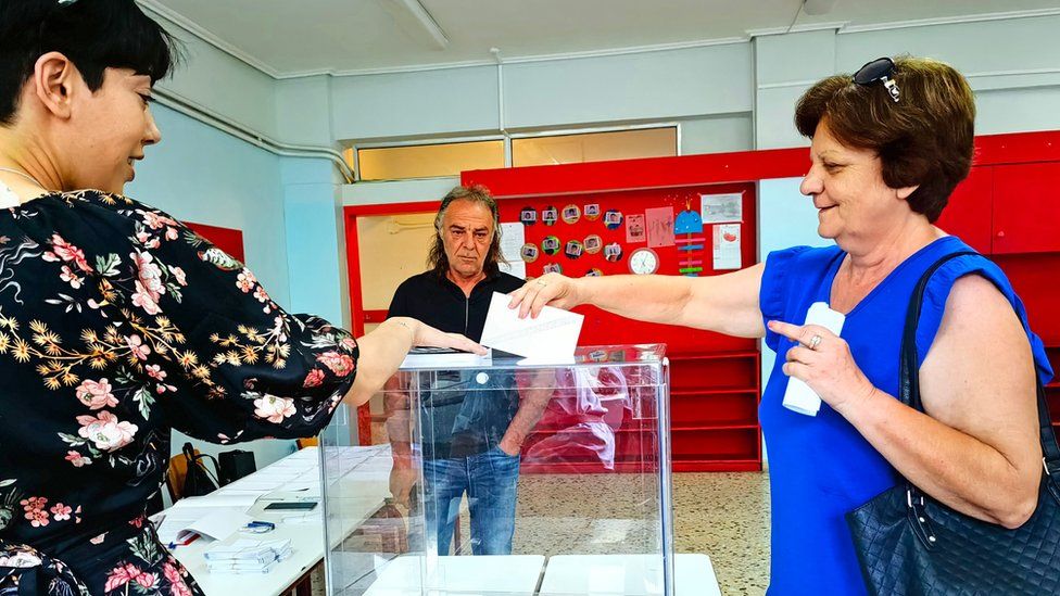 A woman casts her vote during the general elections, at a polling station in Nafplio, Greece, 25 June 2023.