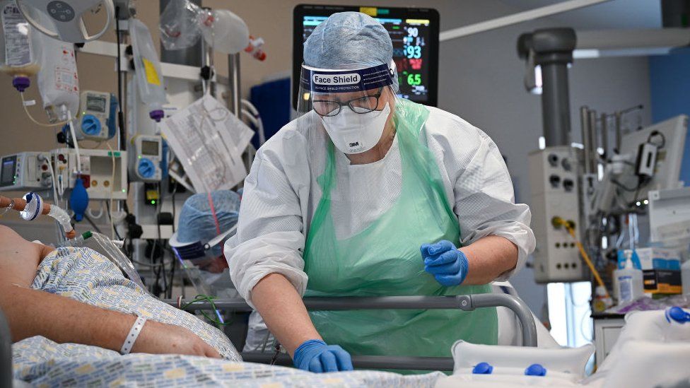 NHS Lanarkshire - A member of staff at University Hospital Monklands attends to a Covid-positive patient on the ICU ward on February 5, 2021