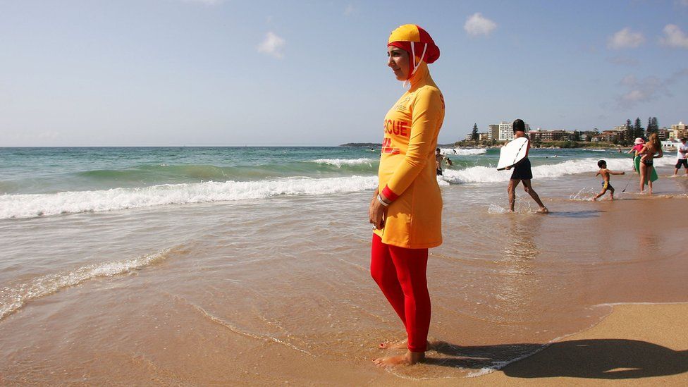 Muslim life guard wearing a burkini on a beach in Sydney, Australia
