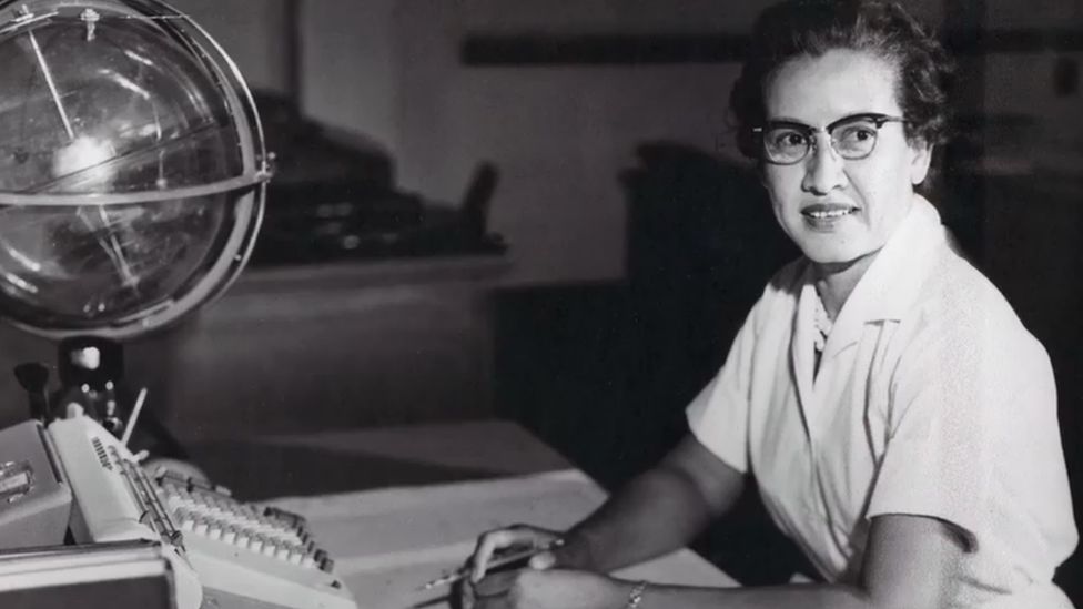 Katherine-Johnson-sits-with-a-globe.