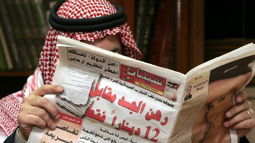 Jordanian man reading paper