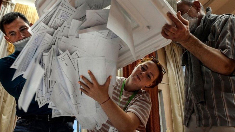 Election officials empty bulletins from a voting box at a polling station in Moscow, Russia. Photo: 1 July 2020