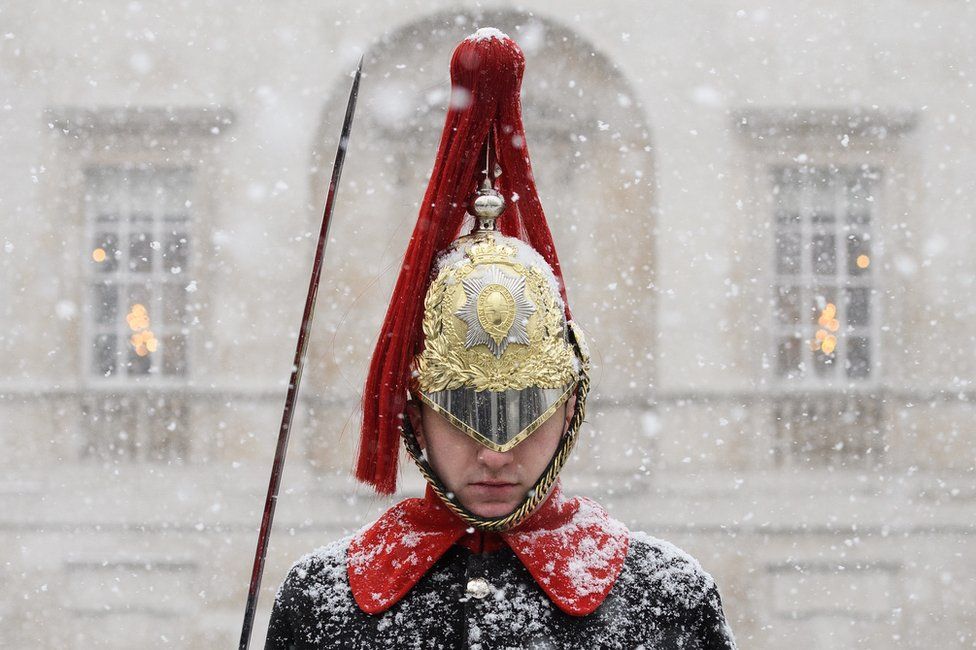 A Household Cavalry Guard stands in the blizzard as heavy snow hits Westminster