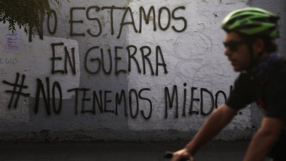 Graffiti on a wall in Santiago proclaims: "We're not at war #we're not afraid"