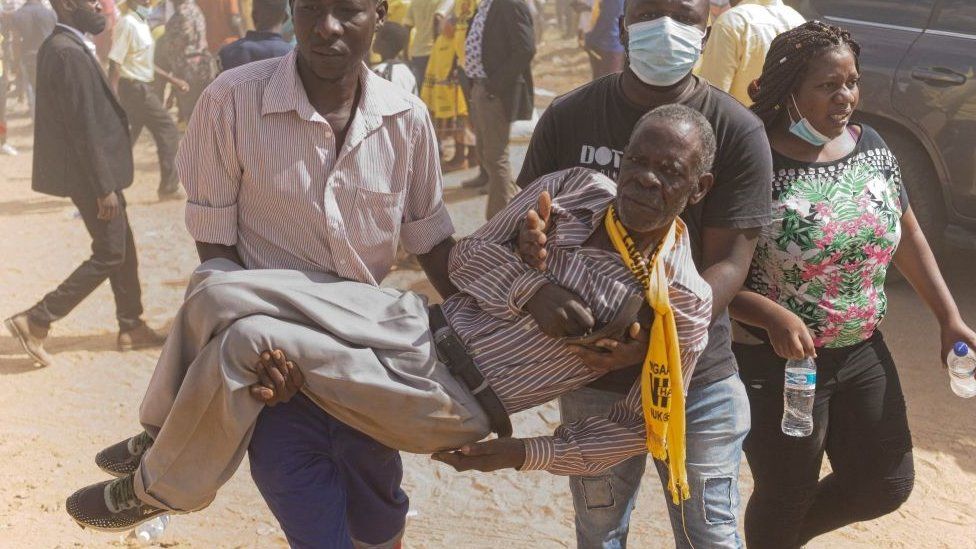 CCC supporter being carried after breaking a leg during a stampede and alleged attack provoked by Zanu-PF supporters