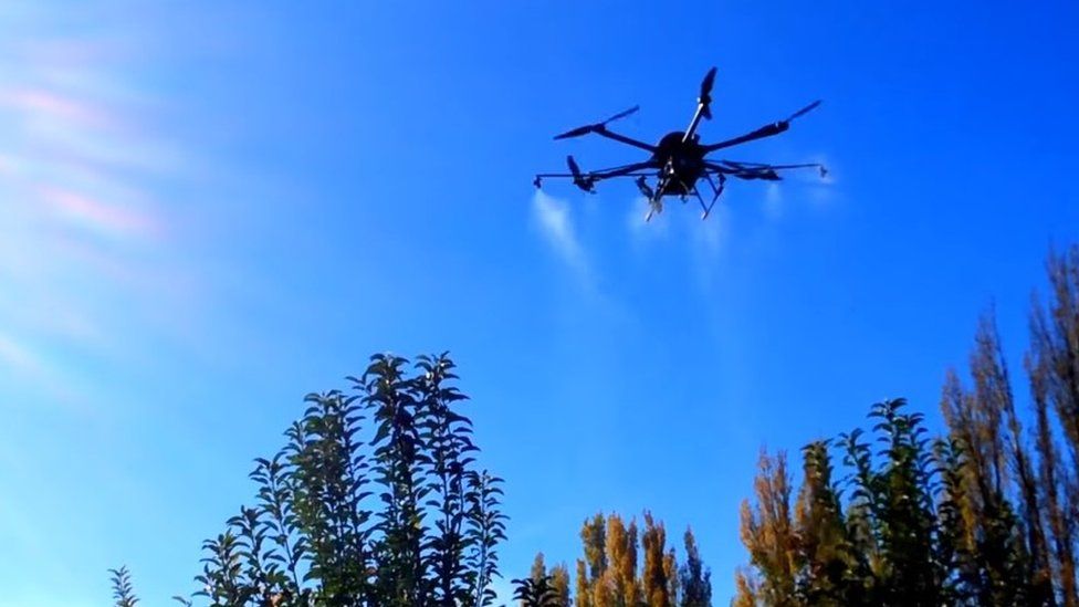 Copter drone spraying fruit trees