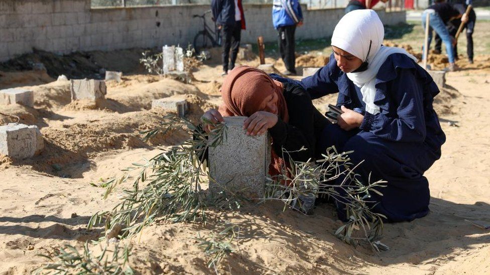 A Palestinian woman reacts at the grave of her son killed in an Israeli strike, Khan Younis in the southern Gaza Strip, 18 January 2024.