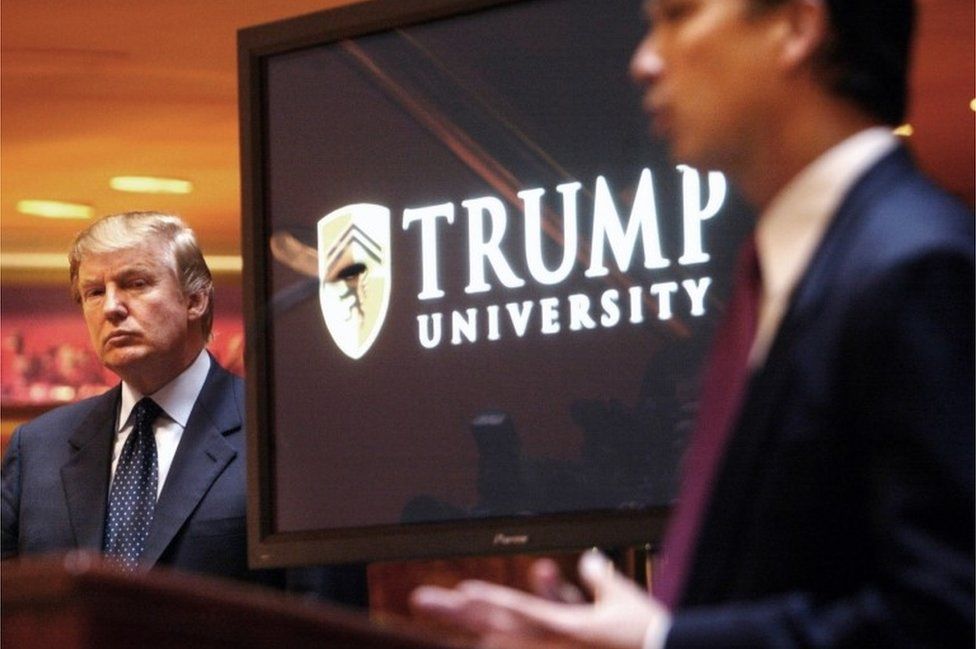 Donald Trump listens as Michael Sexton speaks at the launch of the Trump University investment school in 2005