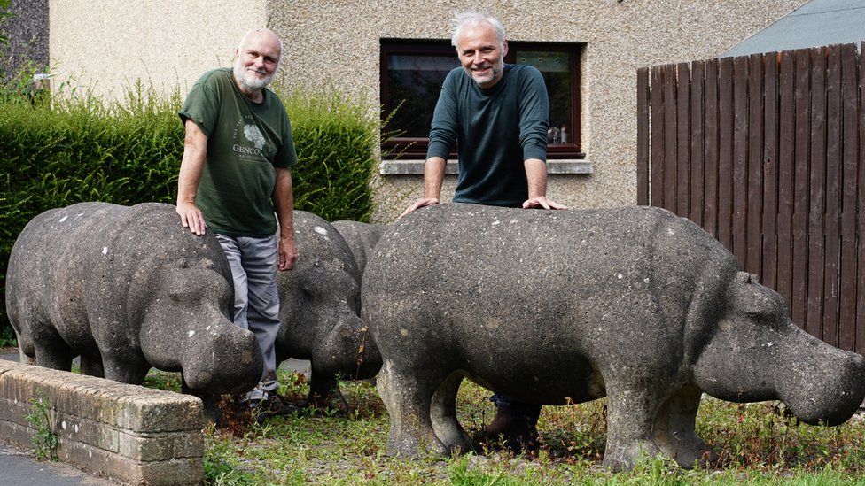 Stan and Mark Bonnar in Glenrothes with concrete hippos made by Stan in the 1970s