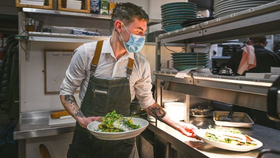 Waiter wearing face mask