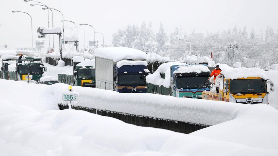 Vehicles are stranded on the snow-covered Kanetsu expressway in Minamiuonuma in Niigata Prefecture,
