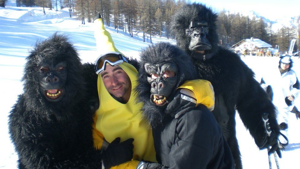 James Kirby dressed as a banana with three people dressed as gorillas on top of a snow-clad mountain