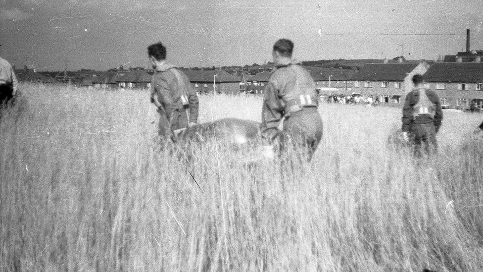 A helicopter crew carry away one of the UFOs